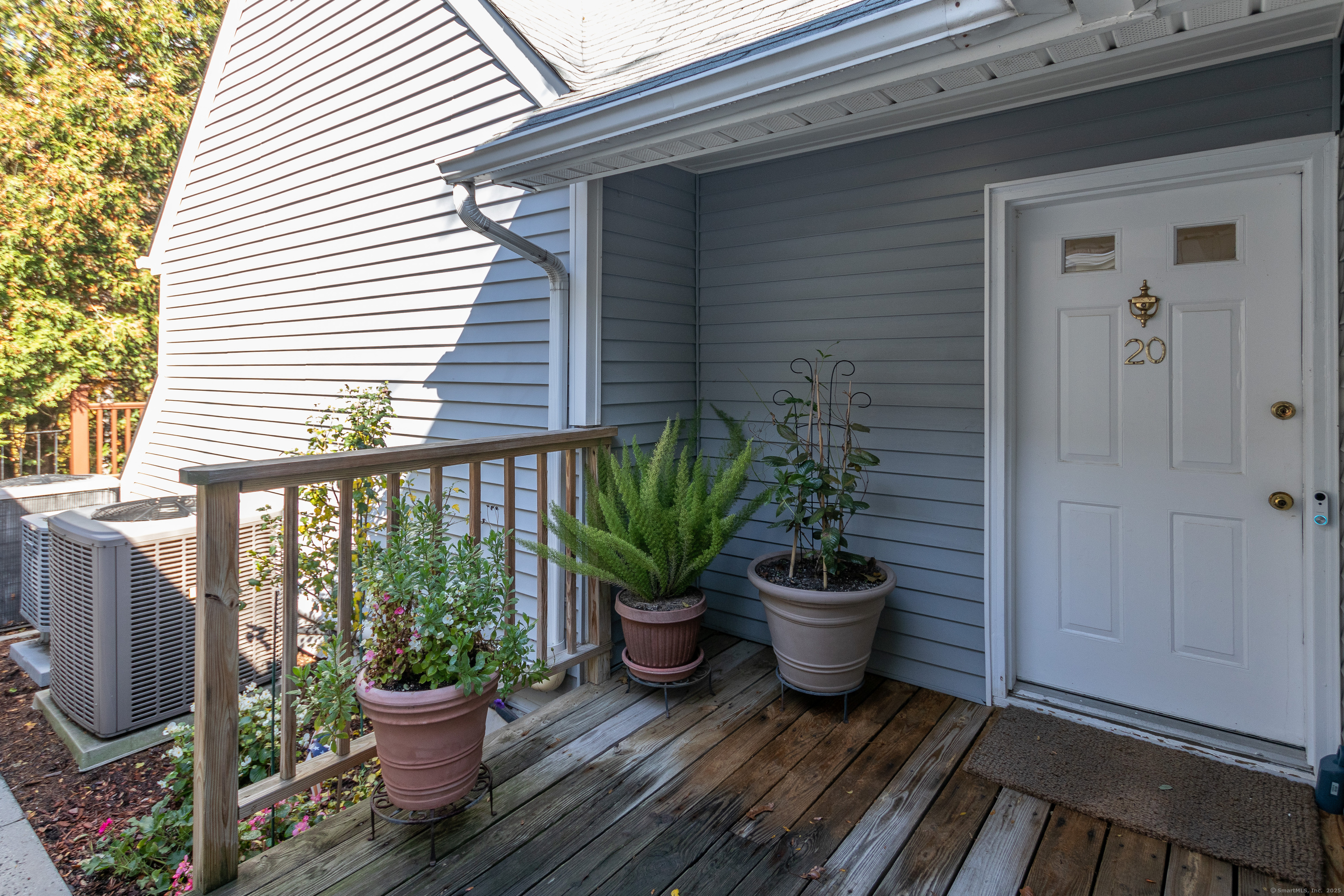 20 Wilton Crest, Unit 20 Wilton, CT 06897 - Photo 39 of 40 a view of a balcony with chair and potted plant