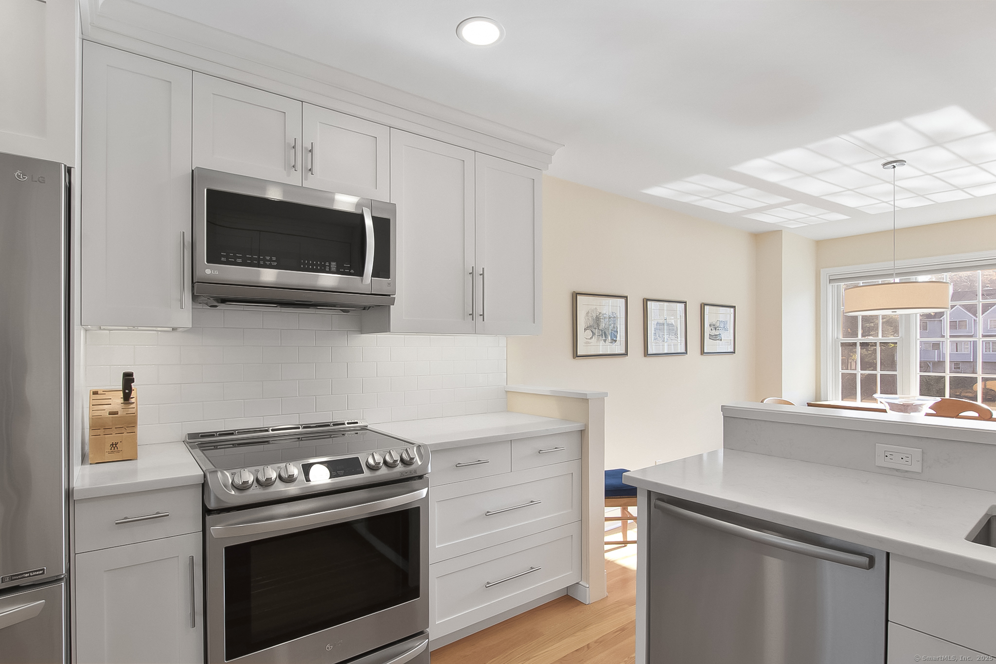 20 Wilton Crest, Unit 20 Wilton, CT 06897 - Photo 6 of 40 a kitchen with cabinets stainless steel appliances and wooden floor