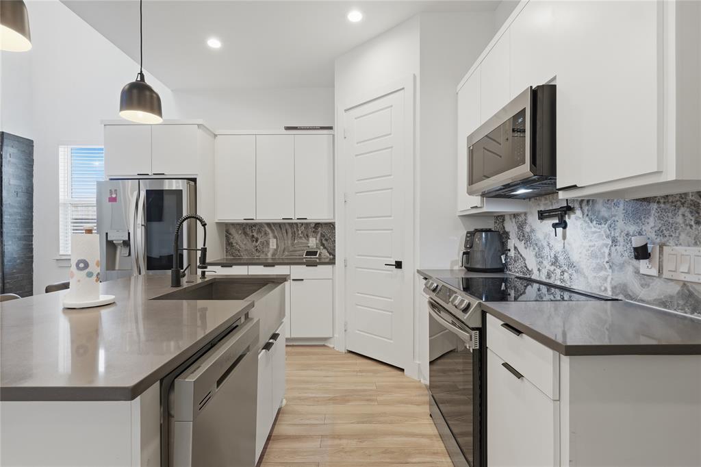 3316 Nomas Street Dallas, TX 75212 - Photo 11 of 27 a kitchen with granite countertop a sink stainless steel appliances and cabinets