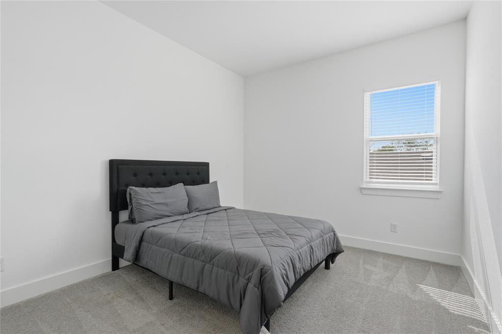 3316 Nomas Street Dallas, TX 75212 - Photo 22 of 27 a bedroom with a bed and a window