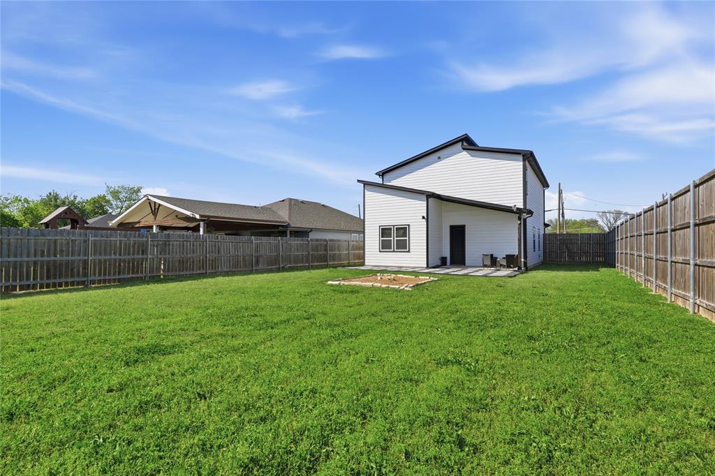 3316 Nomas Street Dallas, TX 75212 - Photo 26 of 27 a front view of house with yard and green space