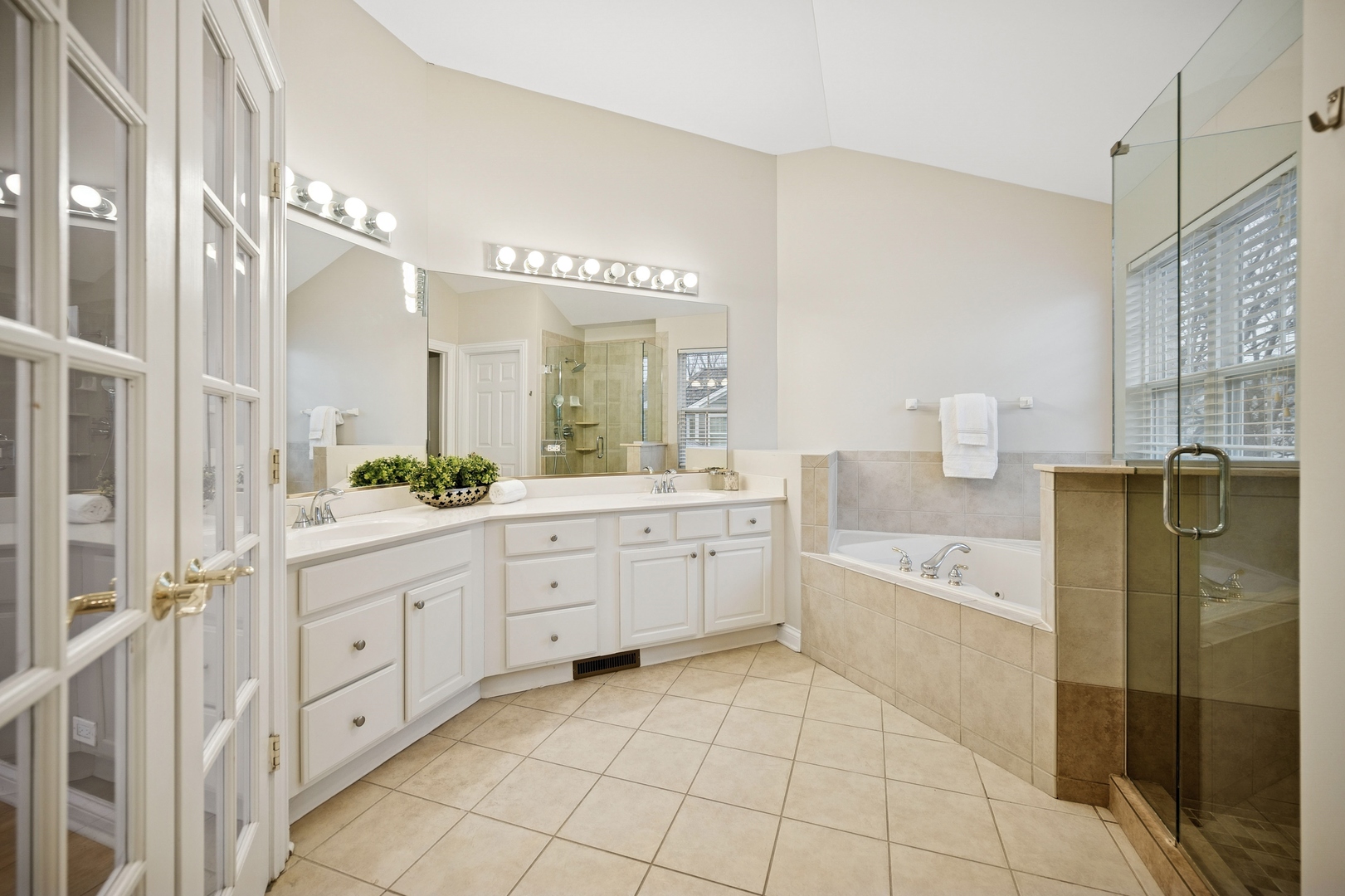 1725 Annapolis Drive Glenview, IL 60026 - Photo 18 of 38 a large bathroom with a granite countertop tub sink shower and mirror