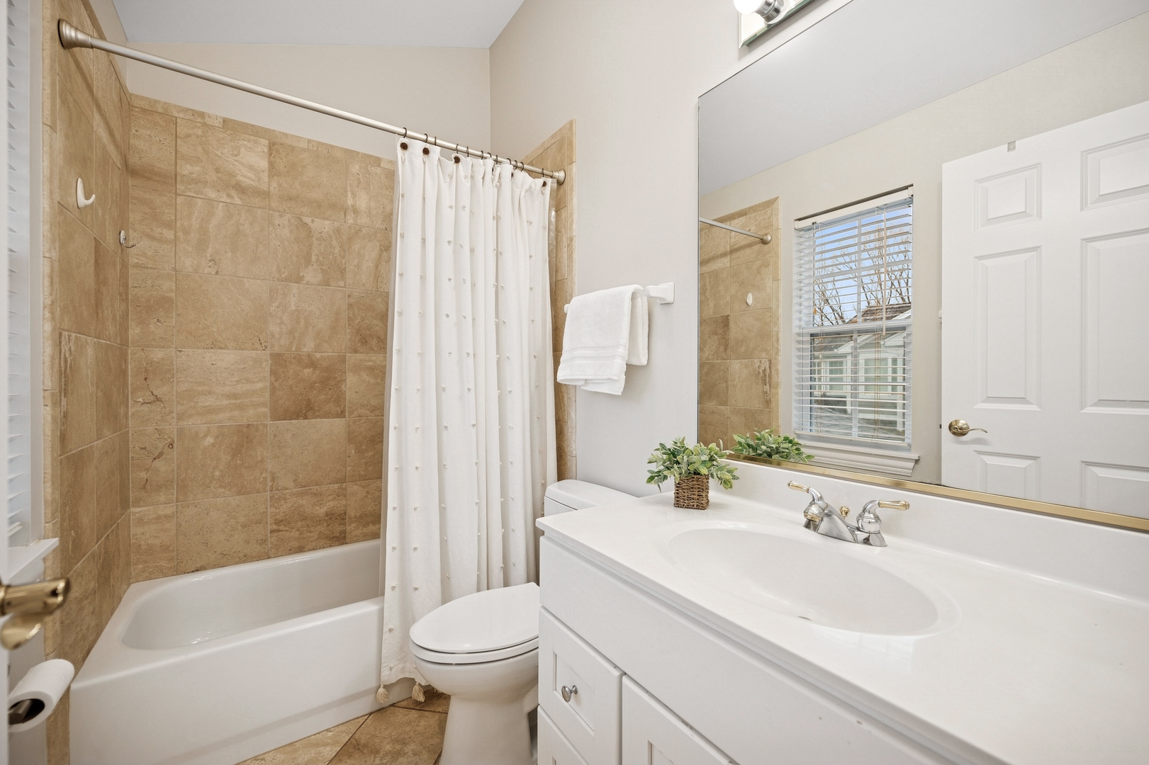 1725 Annapolis Drive Glenview, IL 60026 - Photo 20 of 38 a bathroom with a sink a toilet a mirror a bathtub and shower