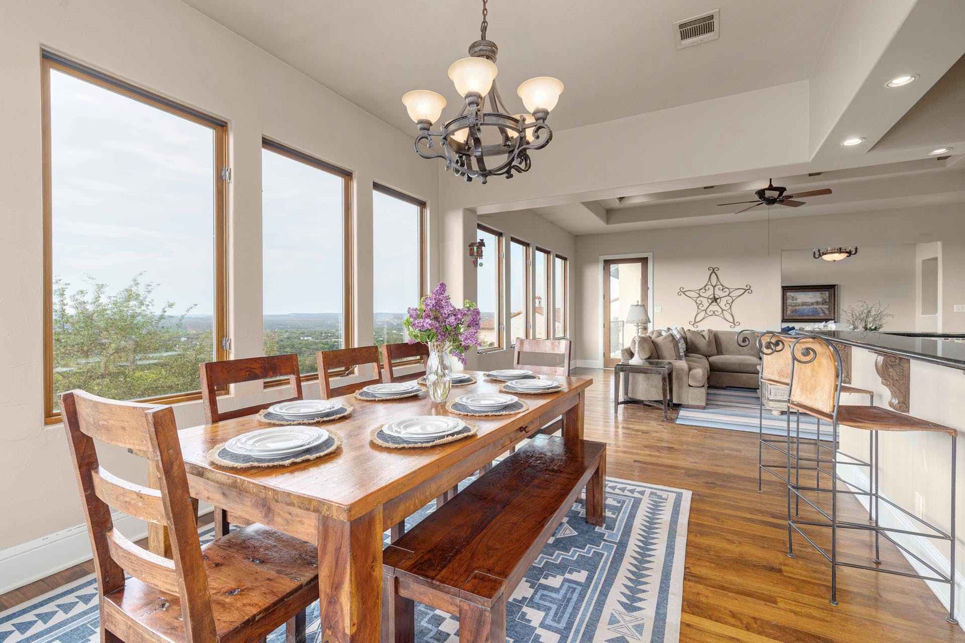 9104 Atwater Cove Austin, TX 78733 - Photo 11 of 36 Dining space with dark wood-style flooring, a ceiling fan, a chandelier, a raised ceiling, and recessed lighting
