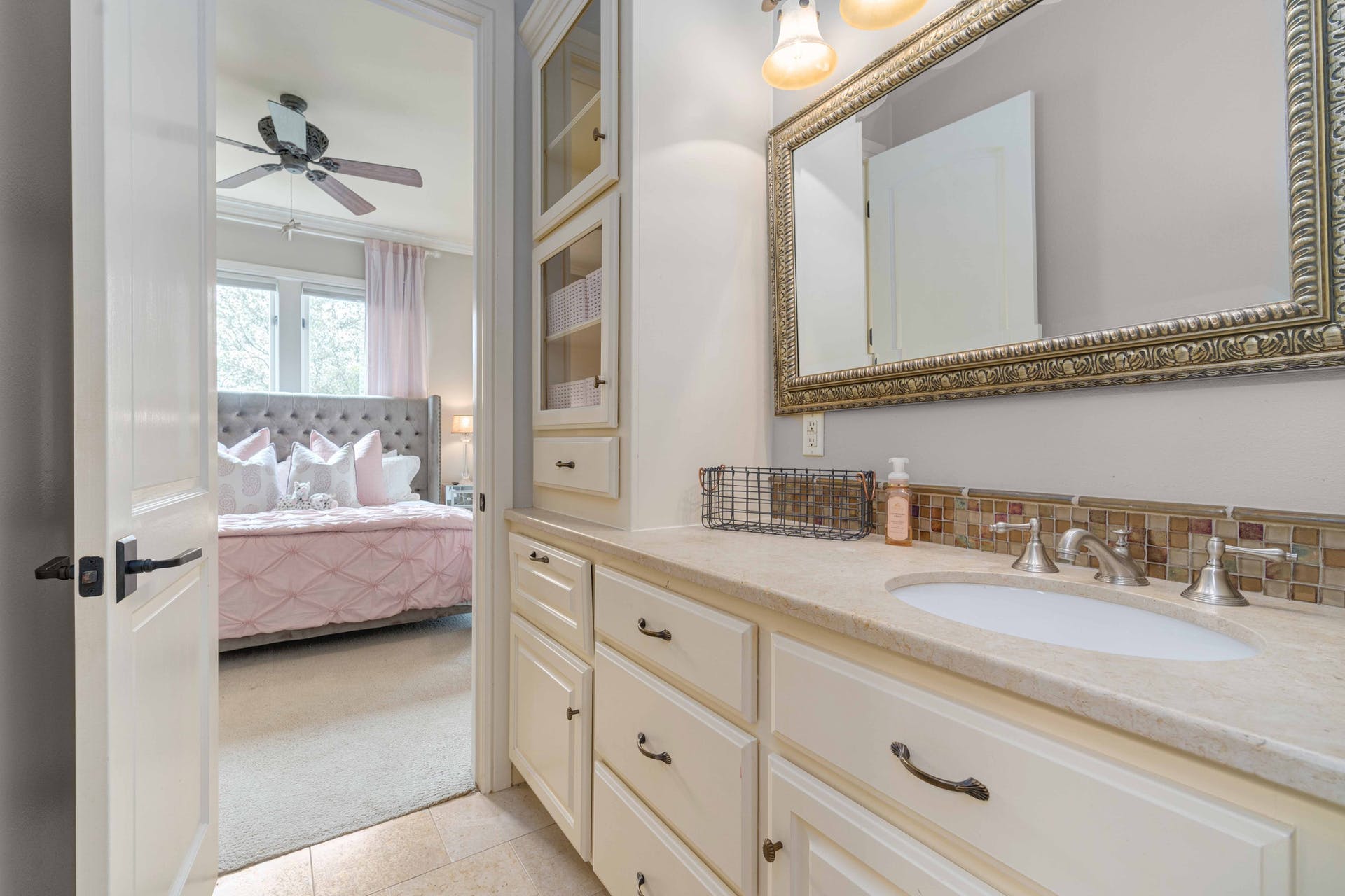 9104 Atwater Cove Austin, TX 78733 - Photo 27 of 36 Ensuite bathroom with vanity, ceiling fan, decorative backsplash, ornamental molding, and light colored carpet