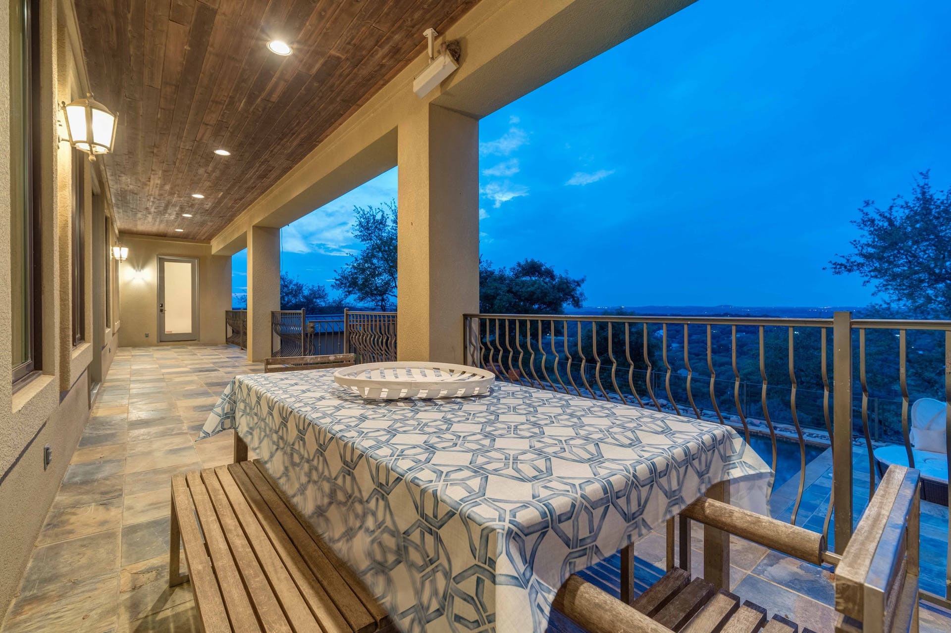 9104 Atwater Cove Austin, TX 78733 - Photo 33 of 36 Balcony at dusk featuring a patio