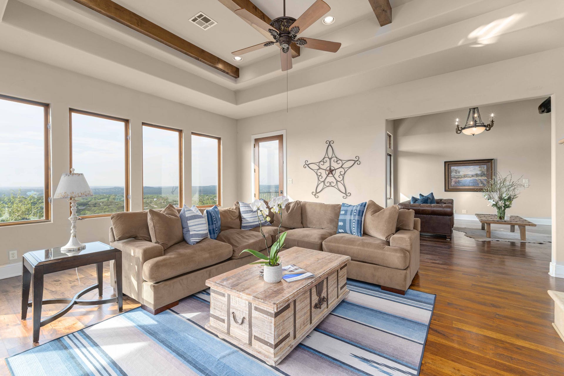 9104 Atwater Cove Austin, TX 78733 - Photo 4 of 36 Living area featuring wood finished floors, recessed lighting, beam ceiling, ceiling fan, and a chandelier