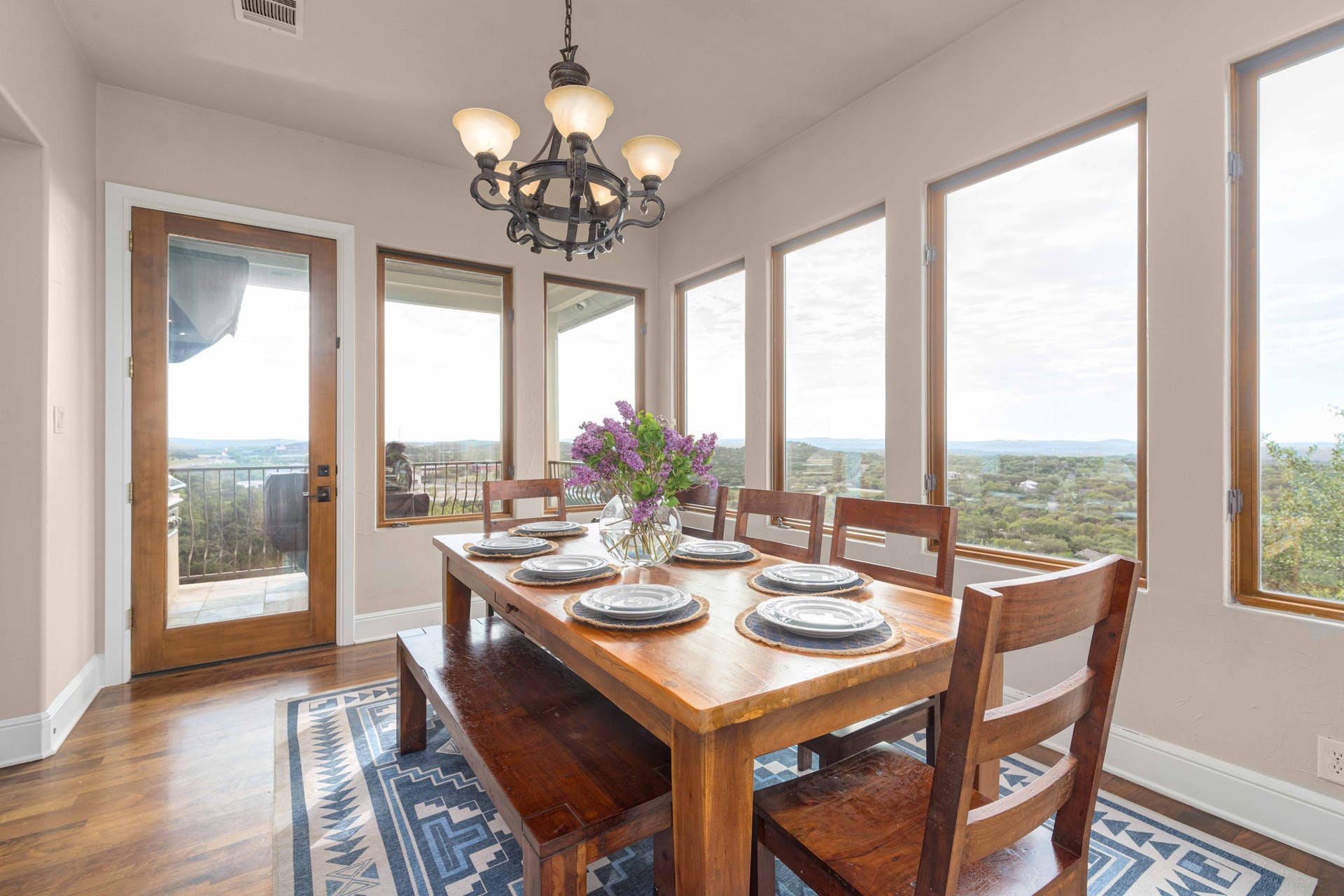 9104 Atwater Cove Austin, TX 78733 - Photo 10 of 36 Dining area featuring a chandelier and wood finished floors