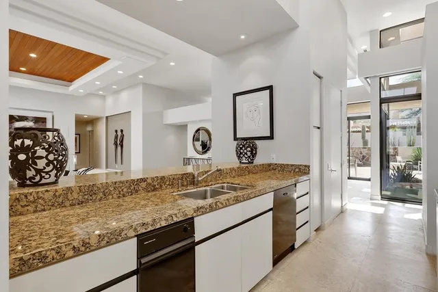a kitchen with sink refrigerator and microwave