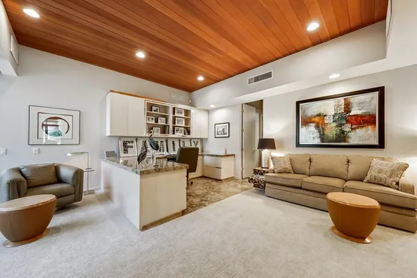 a dining room with furniture and a floor to ceiling window