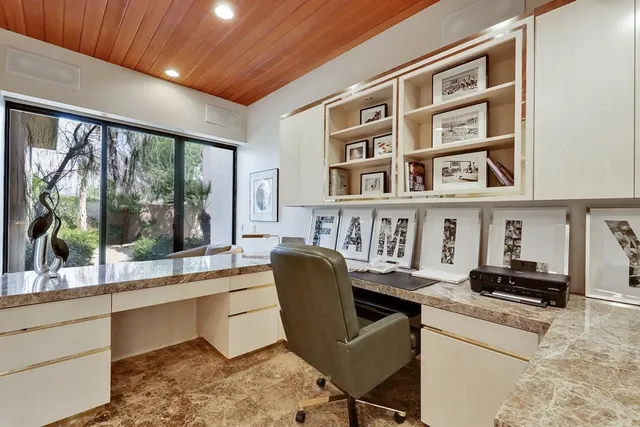 a bedroom with a bed and glass walk in closet