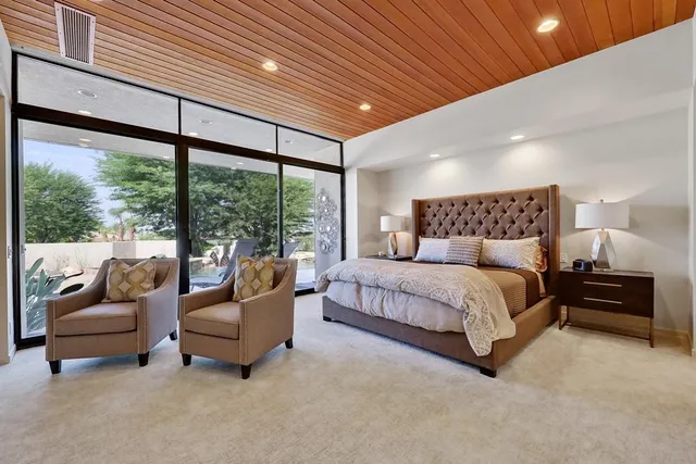 a bedroom with a large bed and a large window