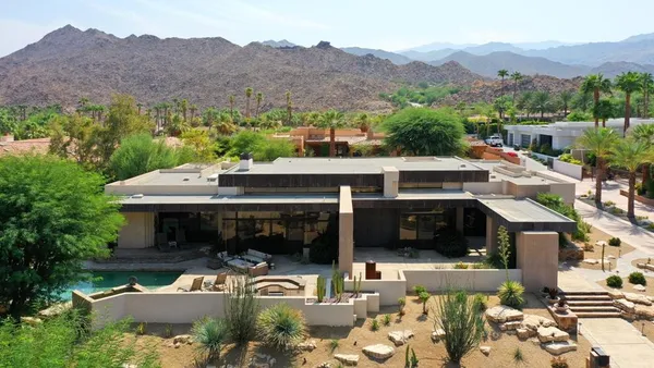 an aerial view of a house with a big yard