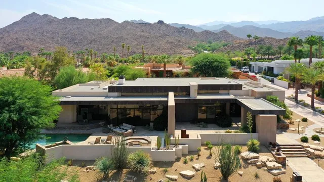 an aerial view of a house with a big yard
