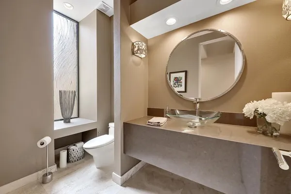 a view of a patio with a table and chairs under an umbrella