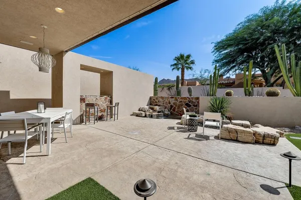 a view of backyard with swimming pool and furniture