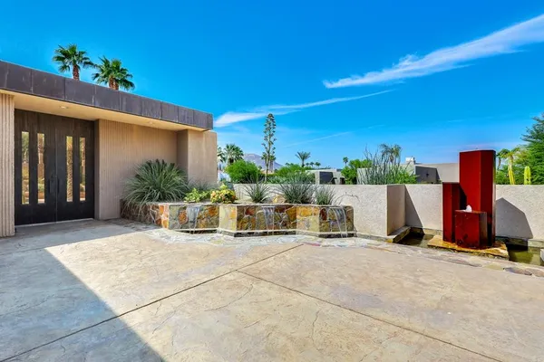 a balcony with furniture and a potted plant