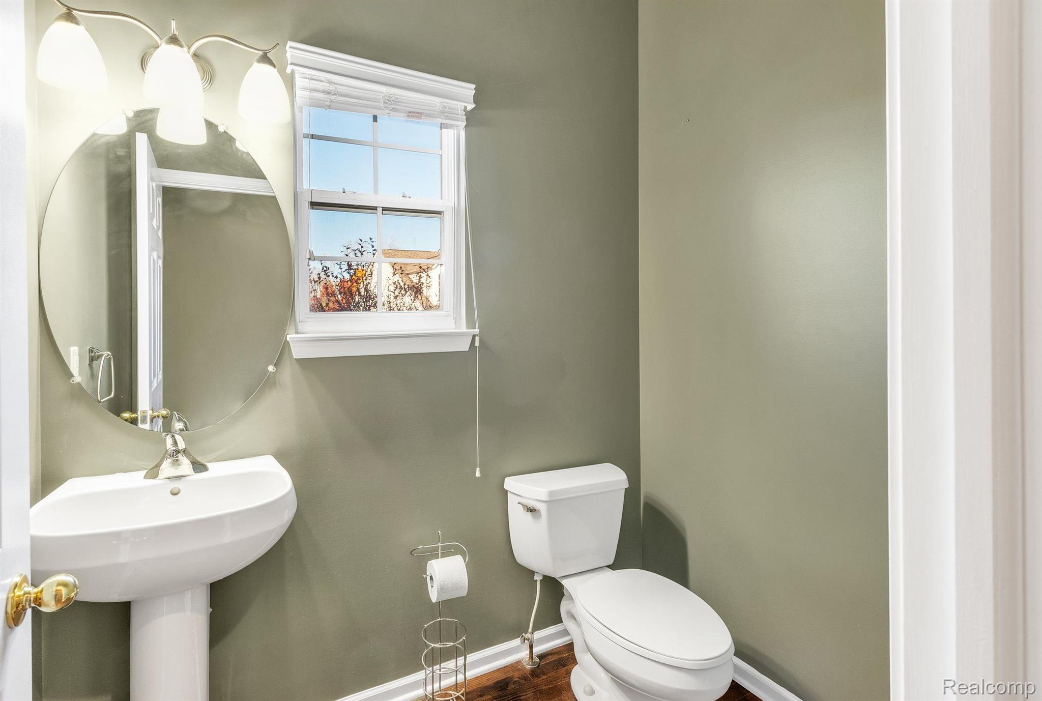 730 East Bluff Court Rochester, MI 48306 - Photo 15 of 34 Half bath has hdwd flooring