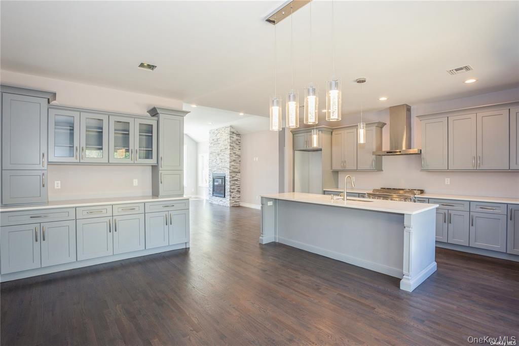 0 Hedda Road Port Jefferson Station, NY 11776 - Photo 2 of 8 a large kitchen with kitchen island a sink wooden floor and white stainless steel appliances