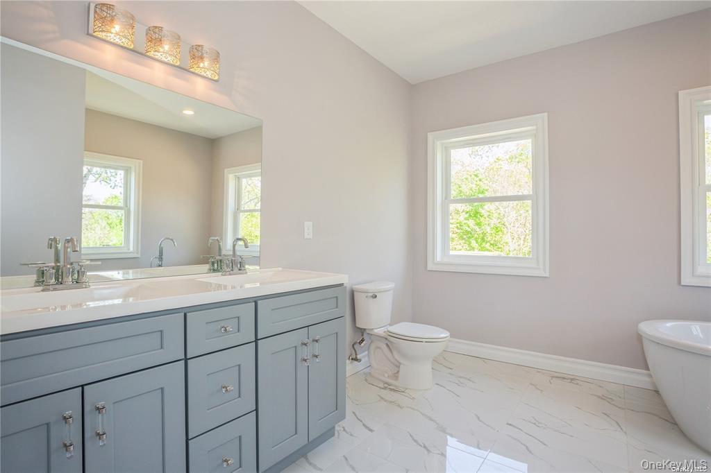 0 Hedda Road Port Jefferson Station, NY 11776 - Photo 6 of 8 a bathroom with a toilet sink and mirror