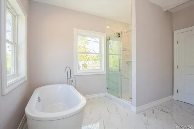 a bathroom with a bathtub and window