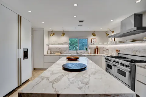 a close view of a stove top oven sitting inside of a kitchen