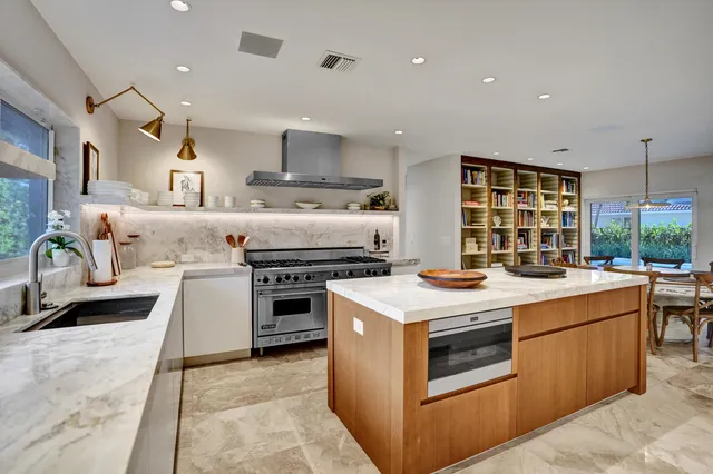 a bedroom with a chandelier and a chandelier