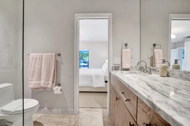 a bedroom with a bed and large window