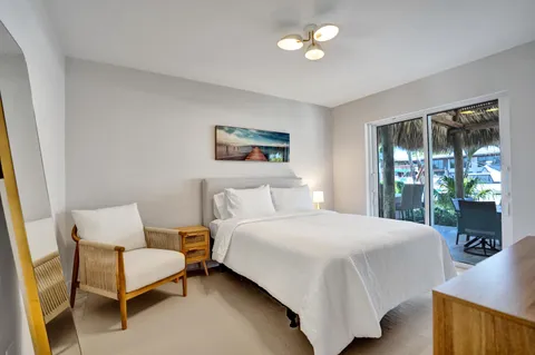 a spacious bedroom with a bed and a painting on the wall