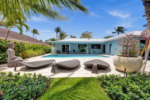 a view of a swimming pool with lounge chairs in patio