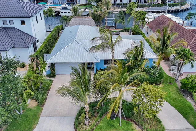 a view of backyard with swimming pool and trees