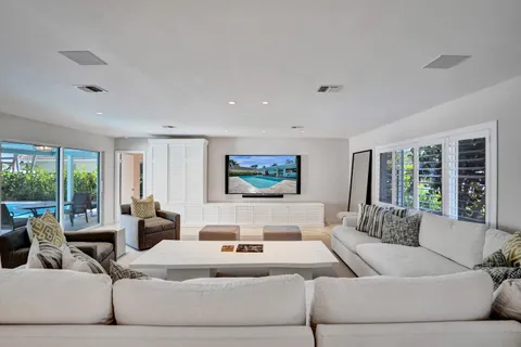 a living room with furniture large window and a flat screen tv