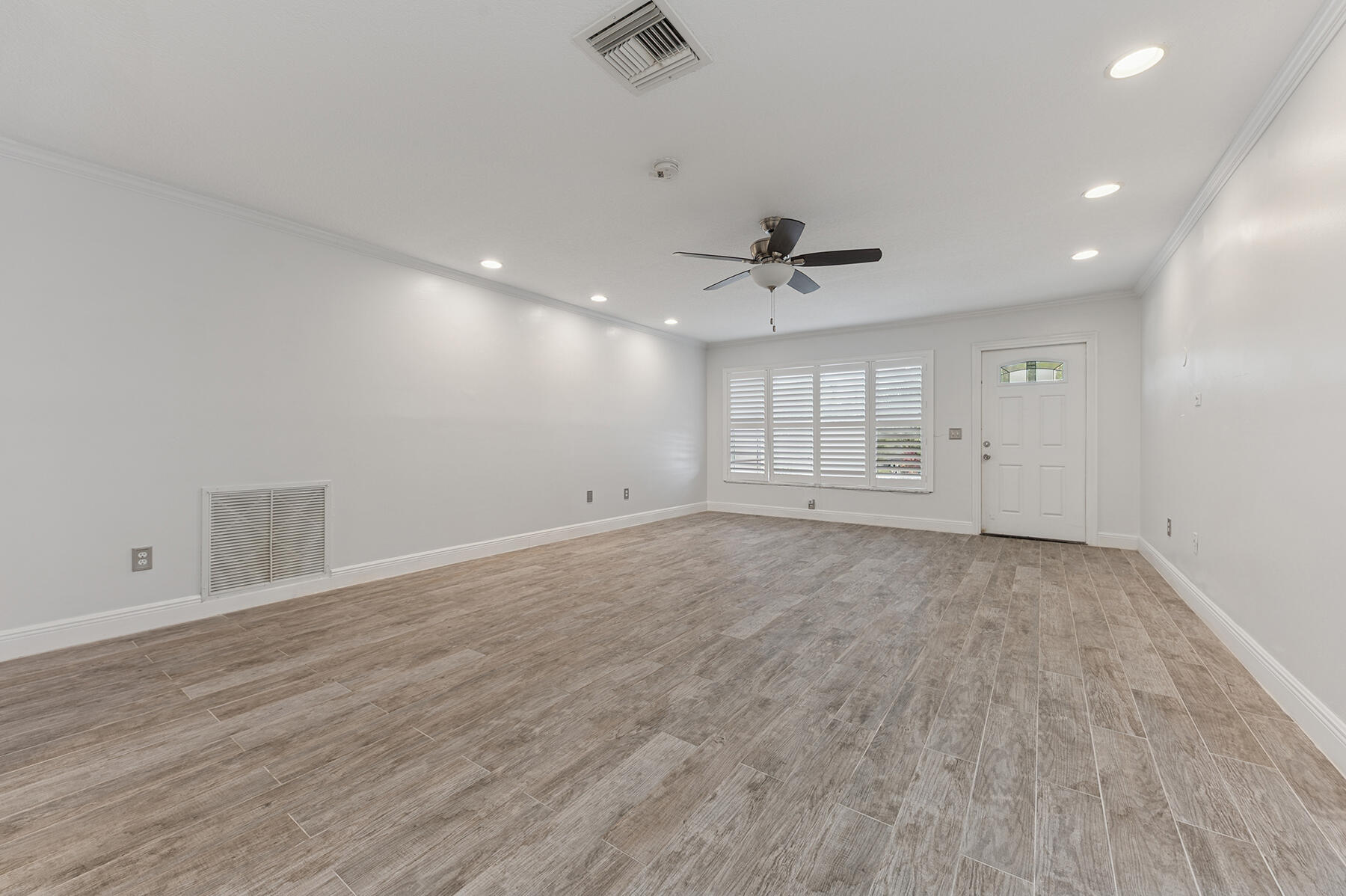 9220 Southwest 2nd Street Boca Raton, FL 33428 - Photo 4 of 16 an empty room with wooden floor and windows