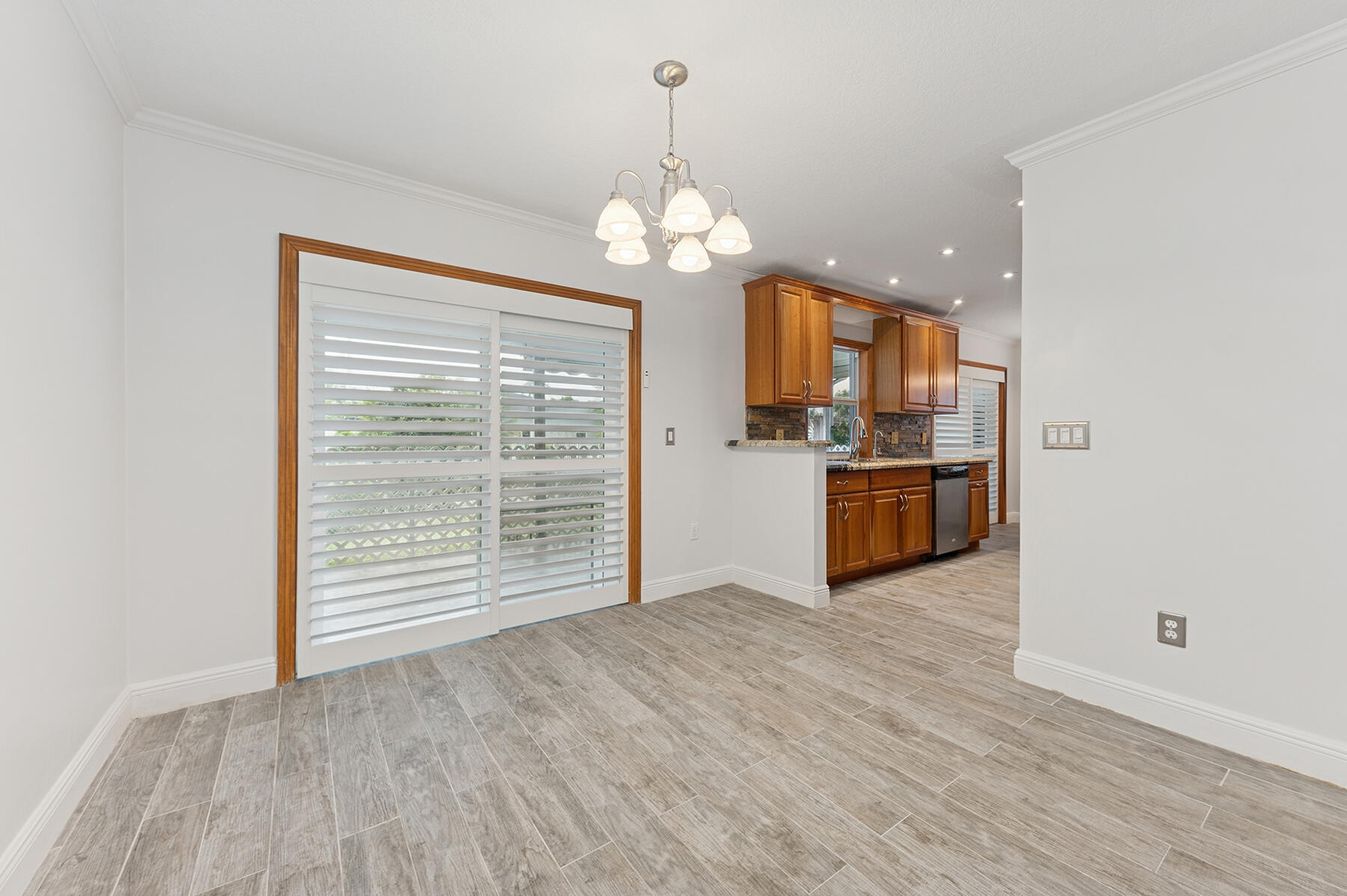 9220 Southwest 2nd Street Boca Raton, FL 33428 - Photo 6 of 16 a view of a kitchen with a stove wooden cabinet wooden floor and a kitchen
