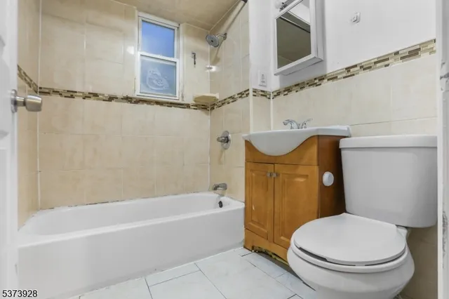 a bathroom with a sink a mirror toilet and bathtub