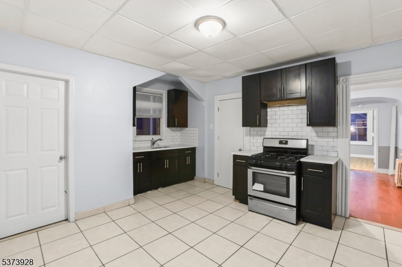 79 Irving Street Newark, NJ 07104 - Photo 17 of 30 a kitchen with stainless steel appliances granite countertop a stove a sink and a refrigerator