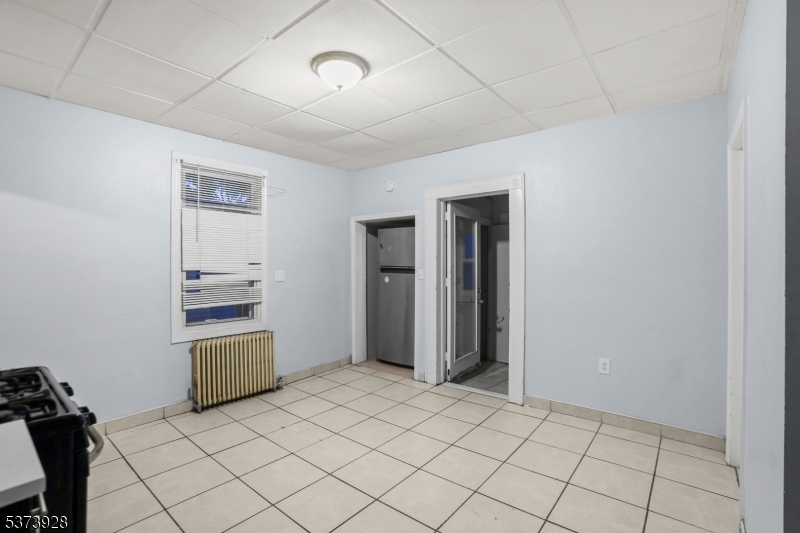 79 Irving Street Newark, NJ 07104 - Photo 18 of 30 a room that has a bed and a chair in it