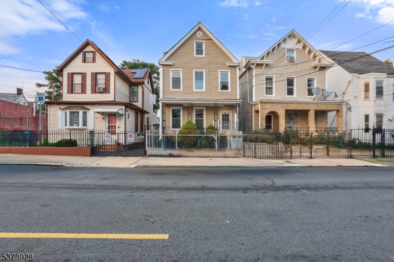 79 Irving Street Newark, NJ 07104 - Photo 2 of 30 a front view of multiple houses