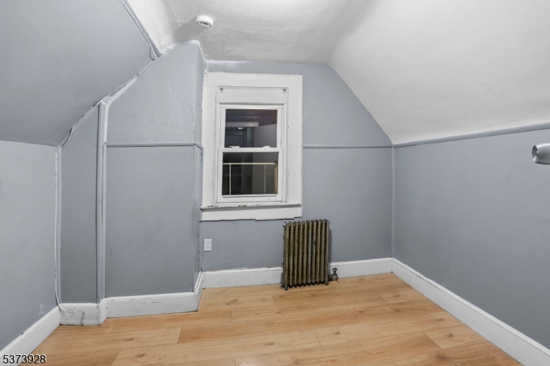 79 Irving Street Newark, NJ 07104 - Photo 25 of 30 a view of empty room with wooden floor and cabinet