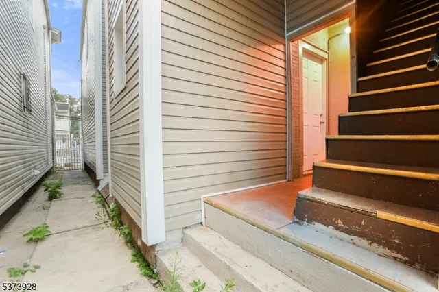 a view of a house with a door and wooden floor