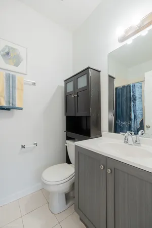a bathroom with a sink a toilet and mirror