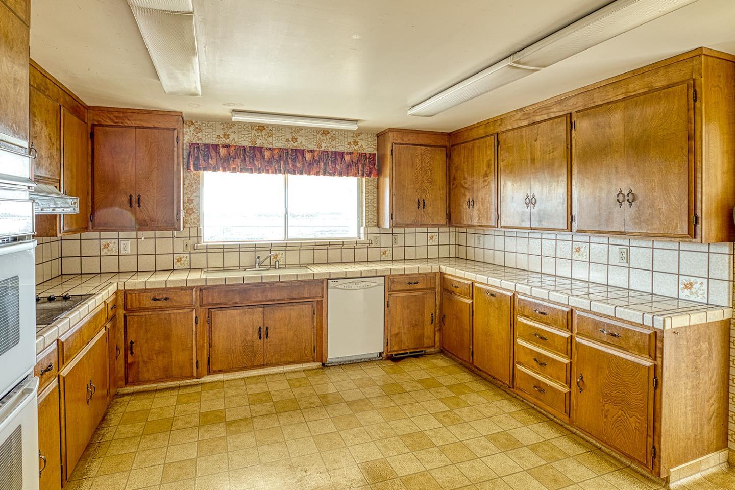 21 Lilly Way Watsonville, CA 95076 - Photo 20 of 47 a large kitchen with stainless steel appliances granite countertop a sink and cabinets