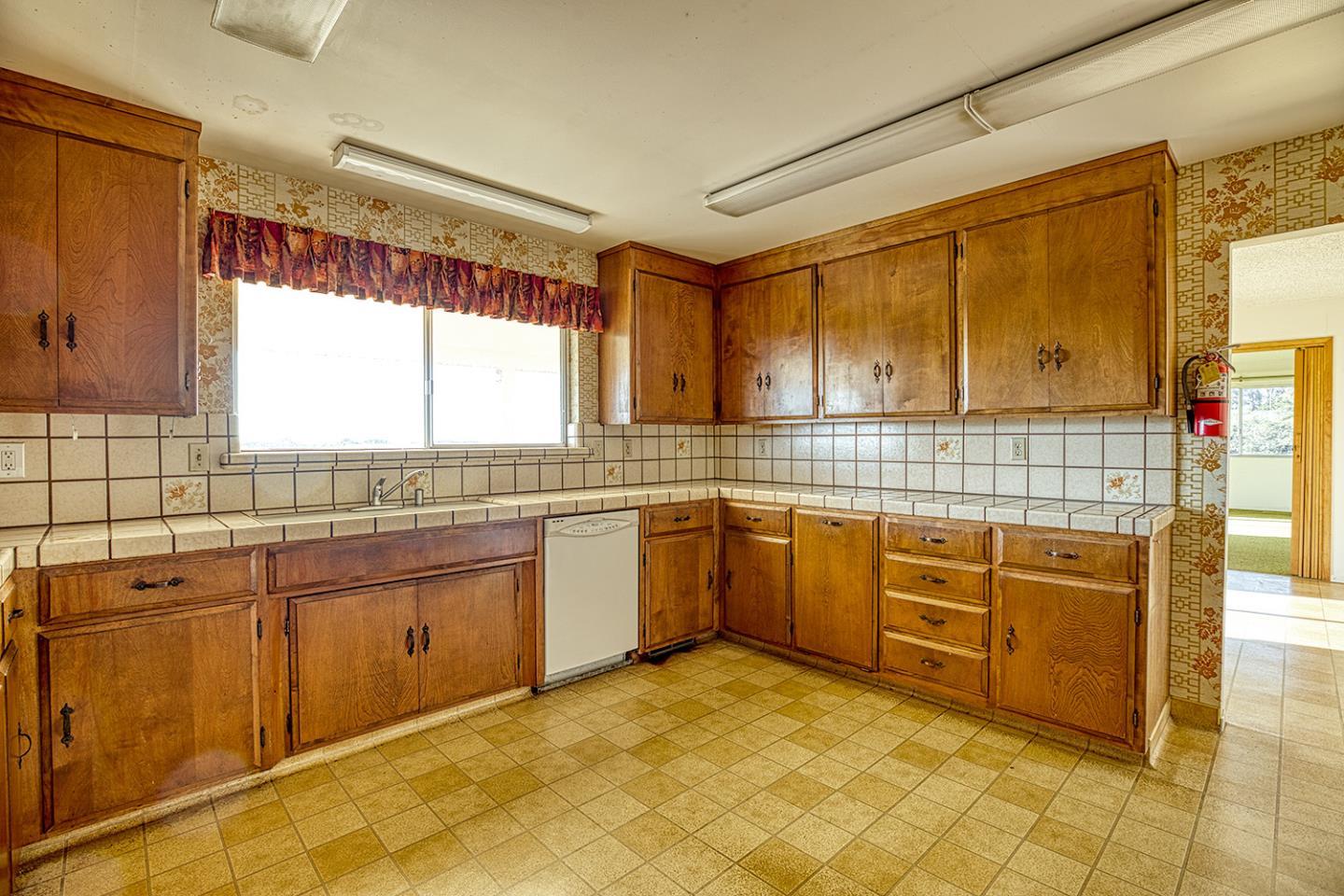 21 Lilly Way Watsonville, CA 95076 - Photo 23 of 47 a kitchen with stainless steel appliances granite countertop a sink and cabinets