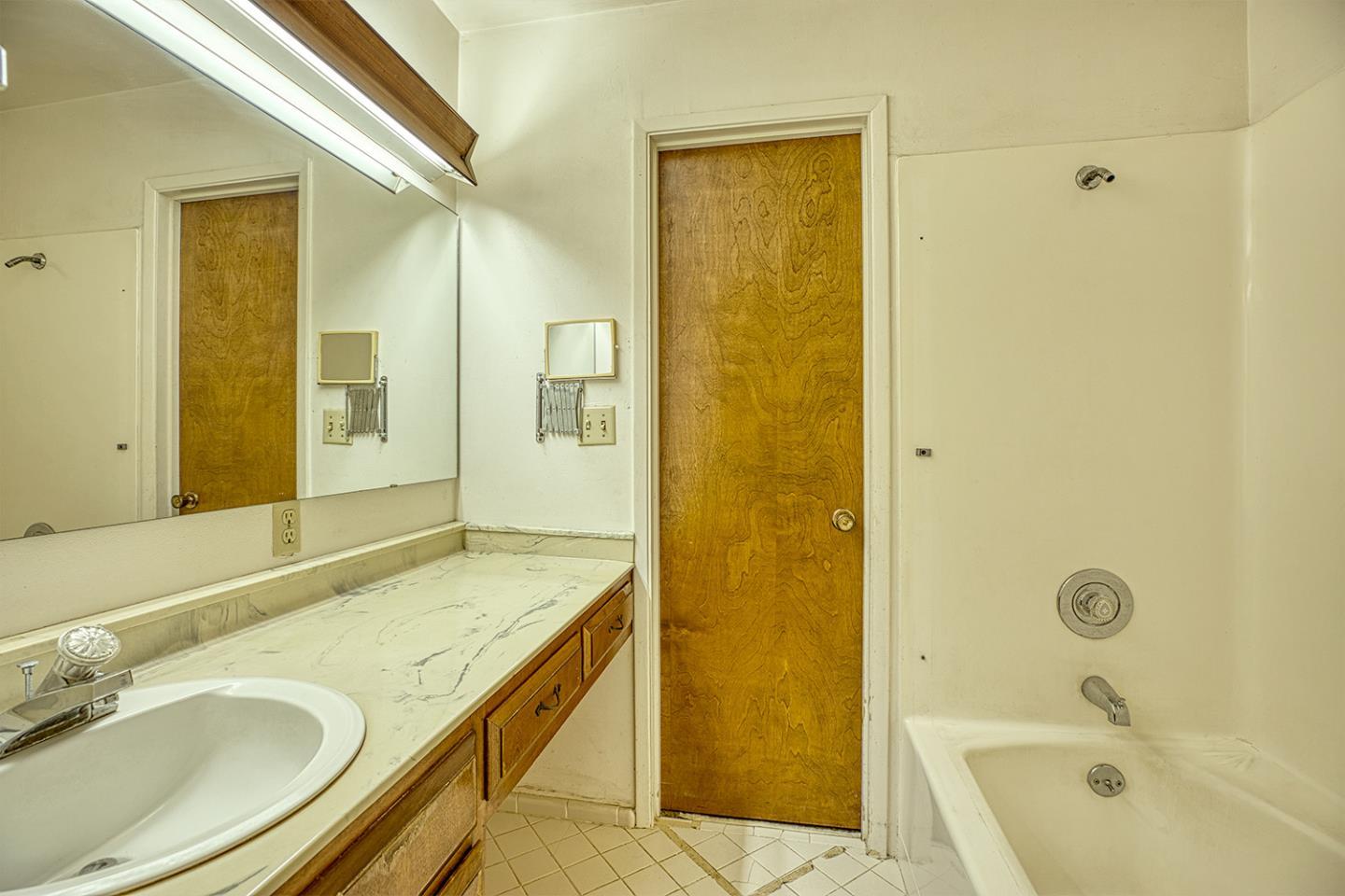 21 Lilly Way Watsonville, CA 95076 - Photo 30 of 47 a bathroom with a granite countertop bathtub shower sink and mirror