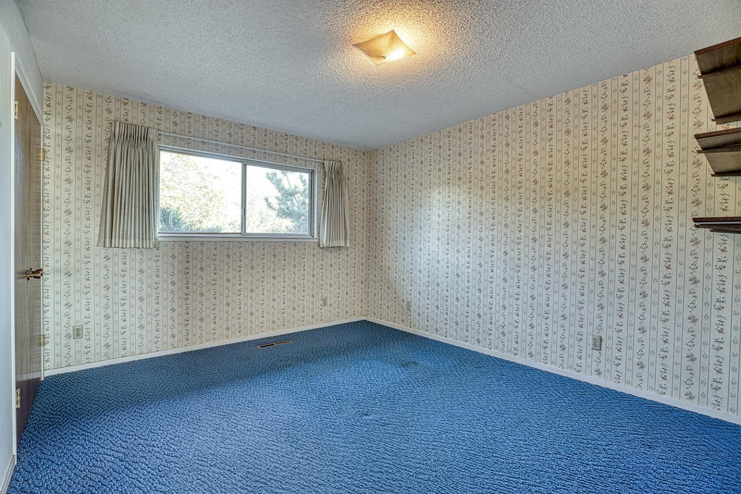 21 Lilly Way Watsonville, CA 95076 - Photo 32 of 47 a view of an empty room with wooden floor and a window