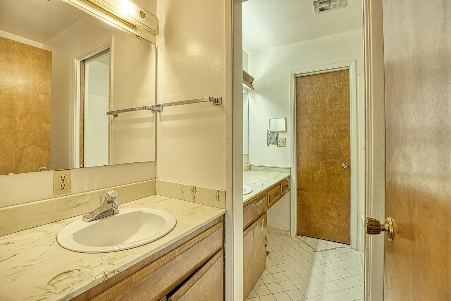 21 Lilly Way Watsonville, CA 95076 - Photo 35 of 47 a bathroom with a granite countertop sink and a mirror