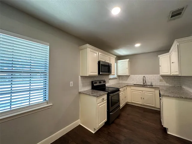 a kitchen with a sink stove and microwave