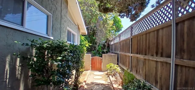 a view of balcony with wooden fence