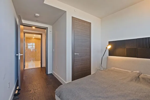 a bedroom with a bed and a potted plant