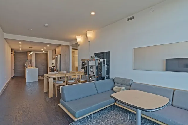a living room with furniture a lamp and a dining table
